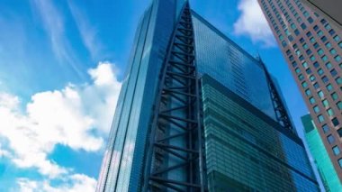 A timelapse of cloud reflecting the building in the business town wide shot panning. High quality 4k footage. Minato district Shiodome Tokyo Japan 07.25.2022 Here is a center of the city in Tokyo. 