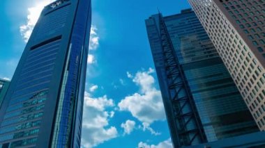 A timelapse of cloud reflecting the building in the business town wide shot. High quality 4k footage. Minato district Shiodome Tokyo Japan 07.25.2022 Here is a center of the city in Tokyo. 