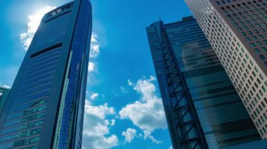 A timelapse of cloud reflecting the building in the business town wide shot tilt. High quality 4k footage. Minato district Shiodome Tokyo Japan 07.25.2022 Here is a center of the city in Tokyo. 