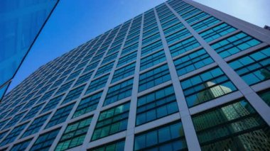 A timelapse of cloud reflecting the building in the business town wide shot. High quality 4k footage. Minato district Shiodome Tokyo Japan 07.25.2022 Here is a center of the city in Tokyo. 