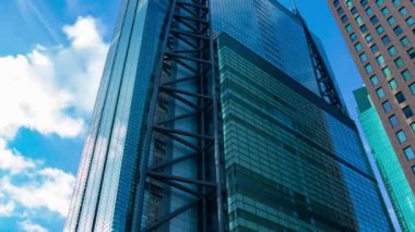 A timelapse of cloud reflecting the building in the business town wide shot zoom. High quality 4k footage. Minato district Shiodome Tokyo Japan 07.25.2022 Here is a center of the city in Tokyo. 
