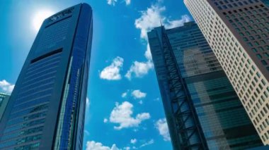 A timelapse of cloud reflecting the building in the business town wide shot zoom. High quality 4k footage. Minato district Shiodome Tokyo Japan 07.25.2022 Here is a center of the city in Tokyo. 
