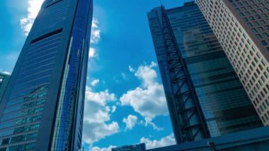 A timelapse of cloud reflecting the building in the business town wide shot tilt. High quality 4k footage. Minato district Shiodome Tokyo Japan 07.25.2022 Here is a center of the city in Tokyo. 