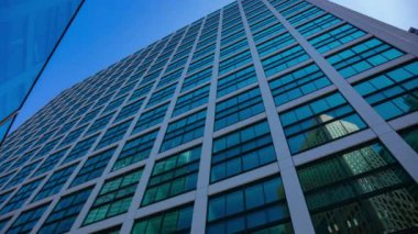 A timelapse of cloud reflecting the building in the business town wide shot tilt. High quality 4k footage. Minato district Shiodome Tokyo Japan 07.25.2022 Here is a center of the city in Tokyo. 