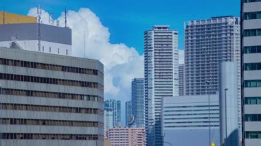 A timelapse of cloud reflecting the building in the business town long shot. High quality 4k footage. Minato district Shiodome Tokyo Japan 07.25.2022 Here is a center of the city in Tokyo. 