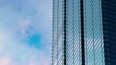 A timelapse of cloud reflecting the building in the business town long shot panning. High quality 4k footage. Minato district Shiodome Tokyo Japan 07.25.2022 Here is a center of the city in Tokyo. 