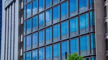 A timelapse of cloud reflecting the building in the business town long shot panning. High quality 4k footage. Chiyoda district Koujimachi Tokyo Japan 07.28.2022 Here is a center of the city in Tokyo. 