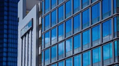 A timelapse of cloud reflecting the building in the business town long shot panning. High quality 4k footage. Chiyoda district Koujimachi Tokyo Japan 07.28.2022 Here is a center of the city in Tokyo. 