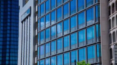 A timelapse of cloud reflecting the building in the business town long shot tilt. High quality 4k footage. Chiyoda district Koujimachi Tokyo Japan 07.28.2022 Here is a center of the city in Tokyo. 