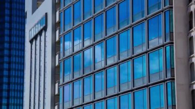 A timelapse of cloud reflecting the building in the business town long shot zoom. High quality 4k footage. Chiyoda district Koujimachi Tokyo Japan 07.28.2022 Here is a center of the city in Tokyo. 
