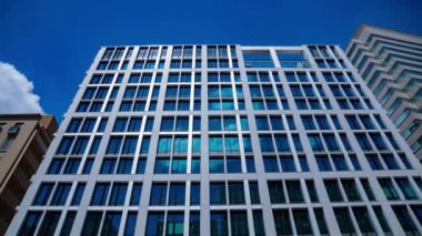 A timelapse of cloud reflecting the building in the business town tilt. High quality 4k footage. Chiyoda district Koujimachi Tokyo Japan 07.28.2022 Here is a center of the city in Tokyo. 