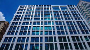 A timelapse of cloud reflecting the building in the business town zoom. High quality 4k footage. Chiyoda district Koujimachi Tokyo Japan 07.28.2022 Here is a center of the city in Tokyo. 