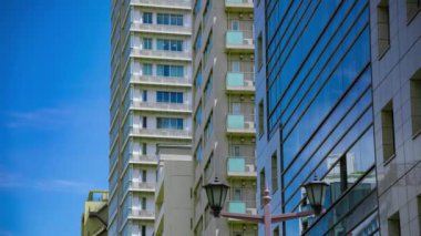 A timelapse of cloud reflecting the building in the business town long shot tilt. High quality 4k footage. Chiyoda district Koujimachi Tokyo Japan 07.28.2022 Here is a center of the city in Tokyo. 