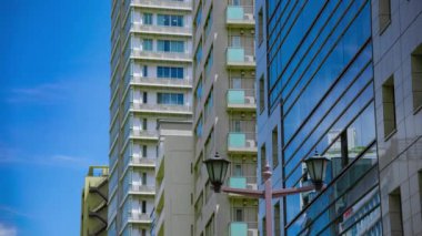 A timelapse of cloud reflecting the building in the business town long shot tilt. High quality 4k footage. Chiyoda district Koujimachi Tokyo Japan 07.28.2022 Here is a center of the city in Tokyo. 
