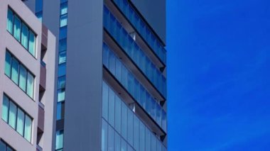 A timelapse of cloud reflecting the building in the business town long shot tilt. High quality 4k footage. Chiyoda district Koujimachi Tokyo Japan 07.28.2022 Here is a center of the city in Tokyo. 