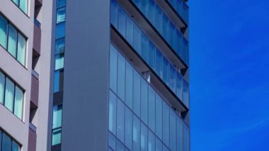 A timelapse of cloud reflecting the building in the business town long shot panning. High quality 4k footage. Chiyoda district Koujimachi Tokyo Japan 07.28.2022 Here is a center of the city in Tokyo. 
