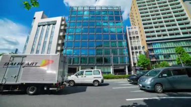 A timelapse of cloud reflecting the building in the business town wide shot tilt. High quality 4k footage. Chiyoda district Koujimachi Tokyo Japan 07.28.2022 Here is a center of the city in Tokyo. 