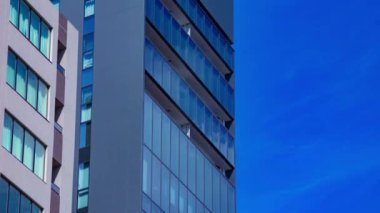 A timelapse of cloud reflecting the building in the business town long shot tilt. High quality 4k footage. Chiyoda district Koujimachi Tokyo Japan 07.28.2022 Here is a center of the city in Tokyo. 