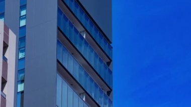 A timelapse of cloud reflecting the building in the business town long shot panning. High quality 4k footage. Chiyoda district Koujimachi Tokyo Japan 07.28.2022 Here is a center of the city in Tokyo. 