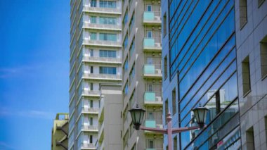 A timelapse of cloud reflecting the building in the business town long shot. High quality 4k footage. Chiyoda district Koujimachi Tokyo Japan 07.28.2022 Here is a center of the city in Tokyo. 