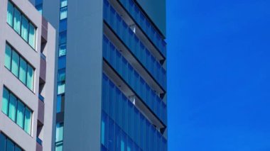 A timelapse of cloud reflecting the building in the business town long shot. High quality 4k footage. Chiyoda district Koujimachi Tokyo Japan 07.28.2022 Here is a center of the city in Tokyo. 