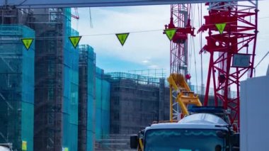A timelapse of moving cranes at the under construction daytime. High quality 4k footage. Nerima district Shakujii Tokyo Japan 07.27.2022