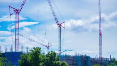 A timelapse of moving cranes at the under construction daytime. High quality 4k footage. Nerima district Shakujii Tokyo Japan 07.27.2022