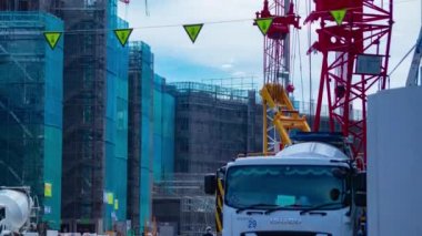 A timelapse of moving cranes at the under construction daytime. High quality 4k footage. Nerima district Shakujii Tokyo Japan 07.27.2022
