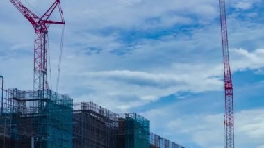 A timelapse of moving cranes at the under construction daytime. High quality 4k footage. Nerima district Shakujii Tokyo Japan 07.27.2022