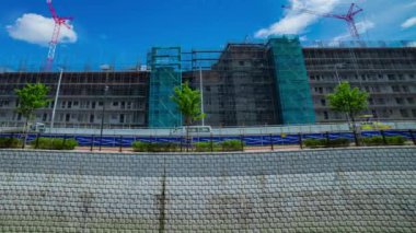 A timelapse of moving cranes at the under construction daytime. High quality 4k footage. Nerima district Shakujii Tokyo Japan 07.27.2022