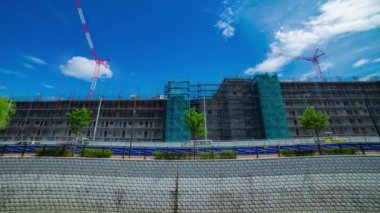 A timelapse of moving cranes at the under construction daytime. High quality 4k footage. Nerima district Shakujii Tokyo Japan 07.27.2022