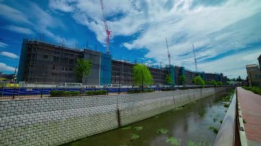 A timelapse of moving cranes at the under construction daytime. High quality 4k footage. Nerima district Shakujii Tokyo Japan 07.27.2022