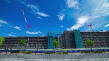 A timelapse of moving cranes at the under construction daytime. High quality 4k footage. Nerima district Shakujii Tokyo Japan 07.27.2022
