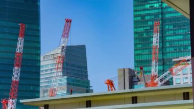 A timelapse of crane at the under construction in Tokyo long shot zoom. High quality 4k footage. Minato district Iikurakatamachi Tokyo Japan 08.09.2022 It is center of the city in Tokyo.