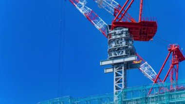 A timelapse of crane at the under construction in Tokyo long shot. High quality 4k footage. Minato district Iikurakatamachi Tokyo Japan 08.09.2022 It is center of the city in Tokyo.