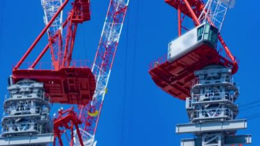 A timelapse of crane at the under construction in Tokyo long shot. High quality 4k footage. Minato district Iikurakatamachi Tokyo Japan 08.09.2022 It is center of the city in Tokyo.