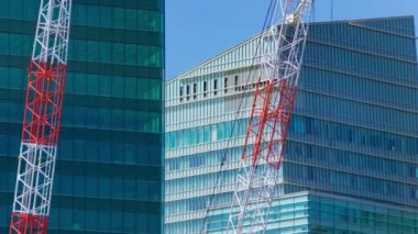 A timelapse of crane at the under construction in Tokyo long shot. High quality 4k footage. Minato district Iikurakatamachi Tokyo Japan 08.09.2022 It is center of the city in Tokyo.