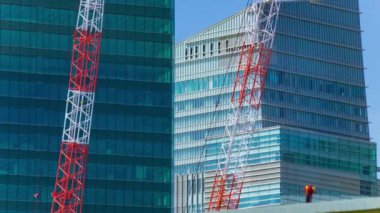 A timelapse of crane at the under construction in Tokyo long shot. High quality 4k footage. Minato district Iikurakatamachi Tokyo Japan 08.09.2022 It is center of the city in Tokyo.