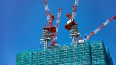 A timelapse of crane at the under construction in Tokyo long shot. High quality 4k footage. Minato district Iikurakatamachi Tokyo Japan 08.09.2022 It is center of the city in Tokyo.