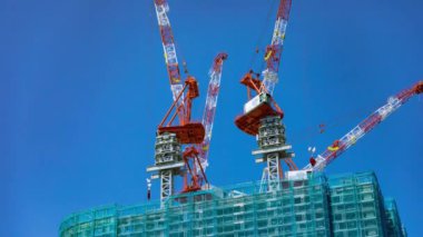 A timelapse of crane at the under construction in Tokyo long shot. High quality 4k footage. Minato district Iikurakatamachi Tokyo Japan 08.09.2022 It is center of the city in Tokyo.
