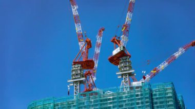 A timelapse of crane at the under construction in Tokyo long shot. High quality 4k footage. Minato district Iikurakatamachi Tokyo Japan 08.09.2022 It is center of the city in Tokyo.