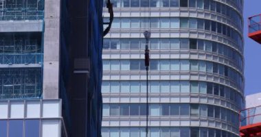 Moving cranes at the under construction daytime long shot. High quality 4k footage. Minato district Iikurakatamachi Tokyo Japan 08.09.2022 It is center of the city in Tokyo.