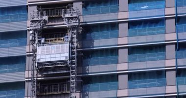 Stopping elevator at the under construction daytime long shot. High quality 4k footage. Minato district Iikurakatamachi Tokyo Japan 08.09.2022 It is center of the city in Tokyo.