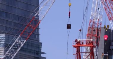 Moving cranes at the under construction daytime long shot. High quality 4k footage. Minato district Iikurakatamachi Tokyo Japan 08.09.2022 It is center of the city in Tokyo.