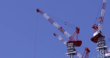 Stopping cranes at the under construction daytime long shot. High quality 4k footage. Minato district Iikurakatamachi Tokyo Japan 08.09.2022 It is center of the city in Tokyo.