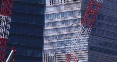 Moving cranes at the under construction daytime long shot. High quality 4k footage. Minato district Iikurakatamachi Tokyo Japan 08.09.2022 It is center of the city in Tokyo.