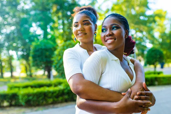 Happy african american one gender couple in love dating outdoors in summer park — Stock Photo, Image