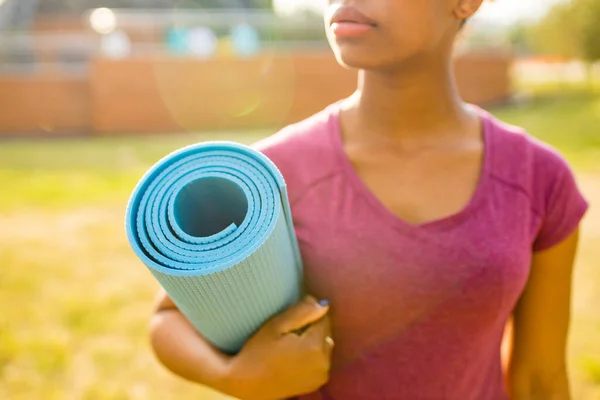 Happy young african american woman trainer with short curly hair ready for yoga time outdoors — Stock Photo, Image