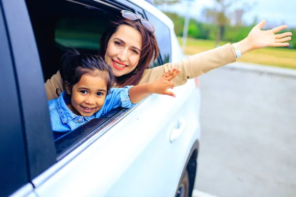 Menina criança feliz com a mãe no carro indo em uma viagem de férias de verão — Fotografia de Stock