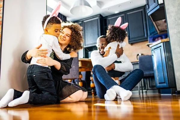 multicultural hispanic family wearing rabbit ears in living room soft sun day light